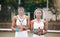 Serious tennis players holding their rackets. Portrait of young tennis players covering their faces with rackets on the