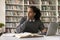 Serious thoughtful African American student guy studying in college library