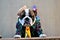 Serious and thoughtful english bulldog wearing a straw hat and green striped shirt