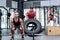 Serious three muscular people lifting and jumping