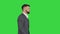 Serious turk businessman in formal suit walking on a Green Screen, Chroma Key.