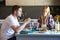 Serious and unhappy young couple eating quinoa salad in the kitchen at home.