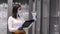 The serious woman in mask is checking the glassware in a shop