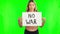 Serious woman, no war sign and billboard on green screen for protest or message on mockup background. Portrait of female