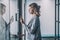 Serious woman opening door with combination lock in office