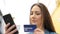 Serious woman paying with credit card online