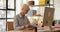 Serious woman sits in office at table and studies documents