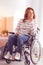 Serious woman sitting in the wheelchair