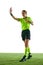 Serious woman, soccer referee gesturing, raising hand forward , stopping game and showing red card against white studio