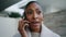 Serious woman talking phone closeup. Worried african american discuss business