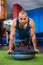 Serious young athlete with BOSU ball in gym