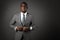 Serious young black man with glasses and gray business suit