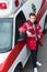 serious young male paramedic standing and leaning