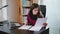 Serious Young Woman Looking on Documents.