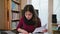 Serious Young Woman Looking on Documents.