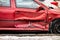 Seriously damaged side door of wine red car after traffic accident