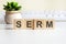 serm word made with wooden blocks on background white keyboard