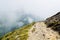 A serpentine path going down in the Carpatian mountains and a bi