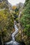 Serra da Estrela Natural Park PORTUGAL - 17 November 2019 - Couple on small bridge in PoÃ§o do Inferno waterfall, landscape in fog