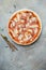 Serrano ham pizza, with parmesan cheese, Italian cuisine, vertical image. top view. place for text
