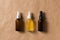 Serum bottles natural organic cosmetic with green leaf on brown