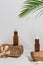 Serum or essential oil in tropical style with leave, rocks,  sea sehlls on white background. Beauty product concept