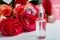 Serum on white table floral background. Flower red pink roses natural beauty product. Skin care,body treatment. Glass cosmetic