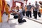 The servant takes a bow while holding a tray and praying