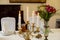 Served banquet restaurant table with candelabrum candles, glasses, napkins and flower vase, selective focus