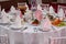 Served for a banquet table. Wine glasses with napkins, glasses.