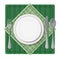 Served dinner plate with cutlery spoon fork and knife on green