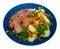 Served dish with fried pork, herbs and potatoes