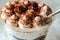 Served Italian dessert Tiramisu, cream, cocoa powder in a plastic take away cup.Healthy food and diet concept, restaurant dish