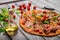 Served pepperoni pizza on a blurred background. Fresh italian pizza. Pizza cooking concept. Traditional italian cuisine.