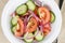 Served plate with mix salad from tomatoes and cucumbers