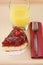 Served romantic breakfast: glass of orange juice and delicious cherry cheese cake