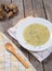 Served soup of Jerusalem artichoke in plate with wooden spoon