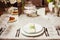 Served table with dishes, utensil, cutlery and dishware on tablecloth