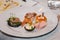 Served table for food and wine tasting. Snacks with shrimp, fish fillets, Spain tapas recipe food pintxos