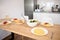 A served table with traditional Italian spaghetti and tomato sauce in white plates, a bowl with wholesome salad and wine