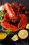 Served whole red lobster close-up with lemon, fresh tomatoes and