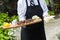 A server holding a wooden tray full of meat snacks during a catered event