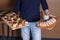 Server holding wooden trays of appetizers in each