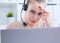 Service desk consultant talking on hands-free phone. Concentration on work. Callcenter voice message system using by