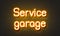 Service garage neon sign on brick wall background.