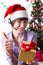 Service operator on Christmas back showing ok sign with present