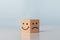 Service rating, ranking, customer review, satisfaction and emotion concept. Wooden Block With Happy And Unhappy Face