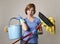 Service woman in washing rubber gloves carrying cleaning bucket