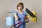 Service woman in washing rubber gloves carrying cleaning bucket