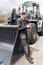 Serviceman with digital tablet on a background of the tractor